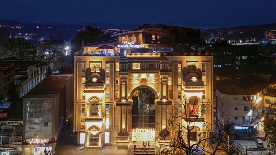 A front angle drone shot of our hotel illuminated with warm yellow lights - Sarovar Premiere, Srinagar